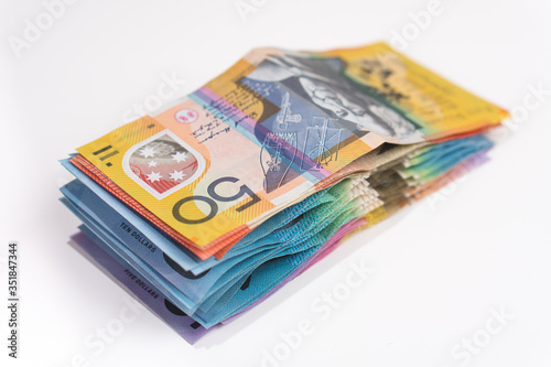 pile of australian money with 50 dollar note on top