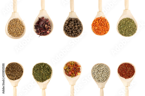 Fototapeta Naklejka Na Ścianę i Meble -  Collection of spices in wooden spoons, isolated on white