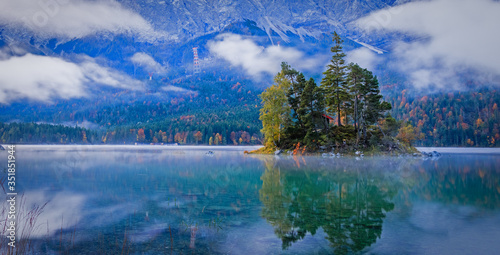 Impressive summer sunrise on Eibsee lake with Zugspitze mountain range. Sunny outdoor scene in German Alps, Bavaria, Germany, Europe. Beauty of nature concept background.