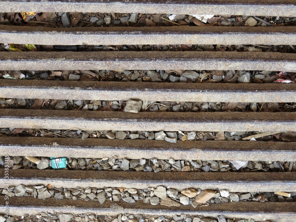 a metal grid on a background of gravel a metal grid on a background of gravel