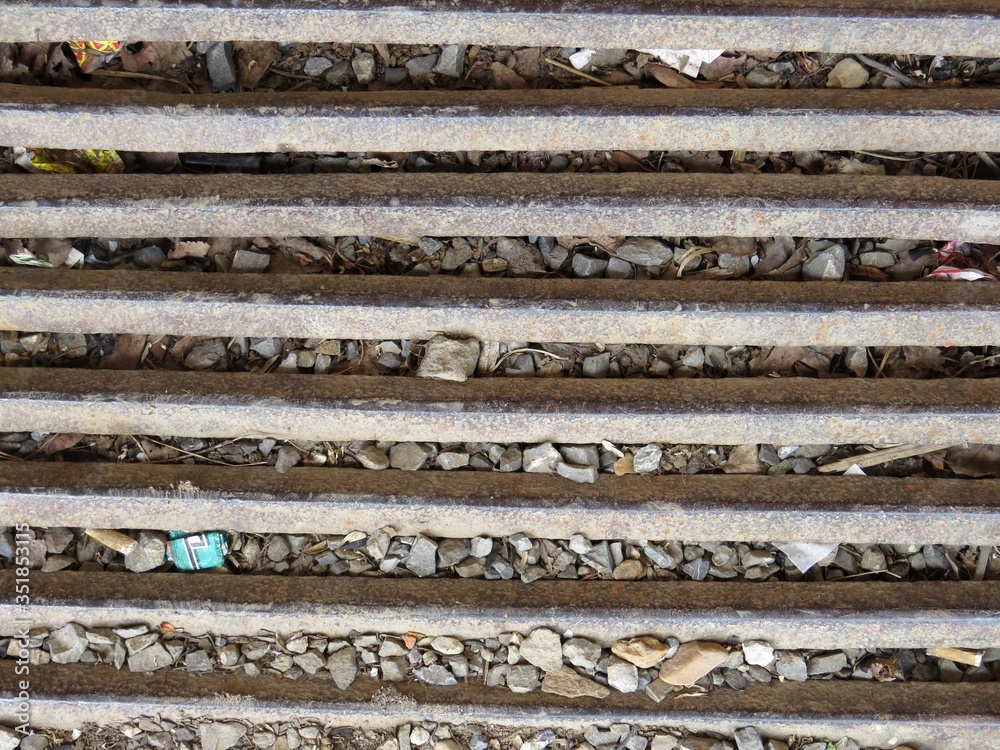 a metal grid on a background of gravel