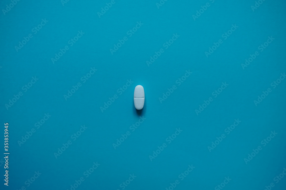 White pills on a paper background with a free area for text White pills on a paper background with a free area for text