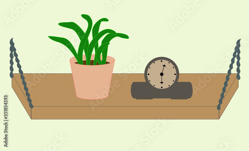 Shelf with a flower and a clock.