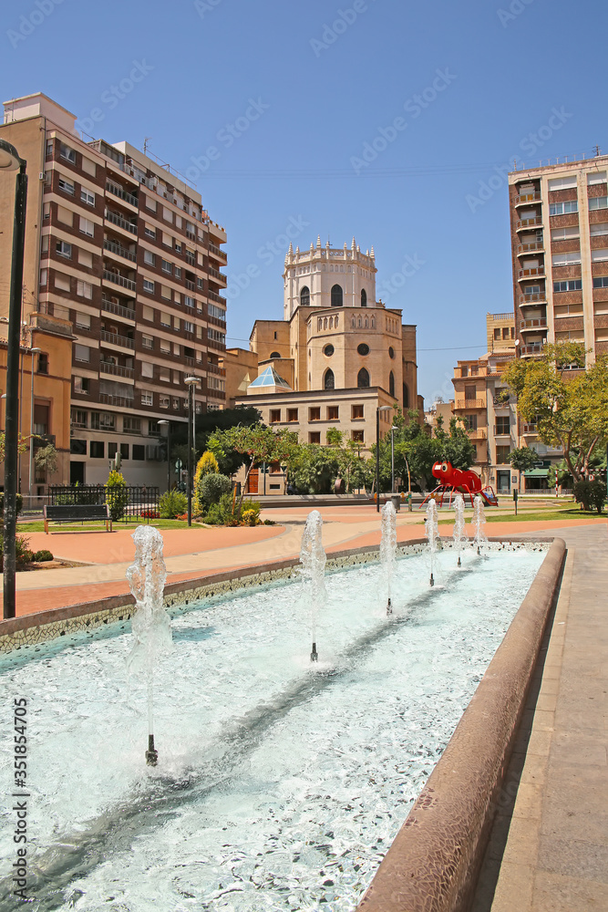 City center fountain in a park with the Cathedral in the background,  in the city of Castellón, Valencia, Spain.