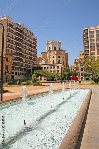 City center fountain in a park with the Cathedral in the background,  in the city of Castellón, Valencia, Spain.