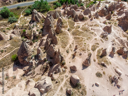 Aerial view of Goreme National Park, Goreme Tarihi Milli Parki, Turkey. The typical rock formations of Cappadocia with fairy chimneys and desert landscape. Travel destinations, holidays and adventure
