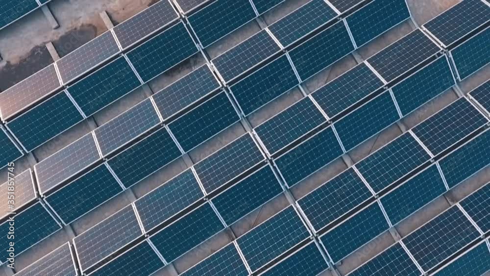 Top view of a new solar farm. Rows of modern photovoltaic solar panels. Renewable ecological source of energy from the sun. Aerial view. Top view of a new solar farm. Rows of modern photovoltaic solar panels. Renewable ecological source of energy from the sun. Aerial view.