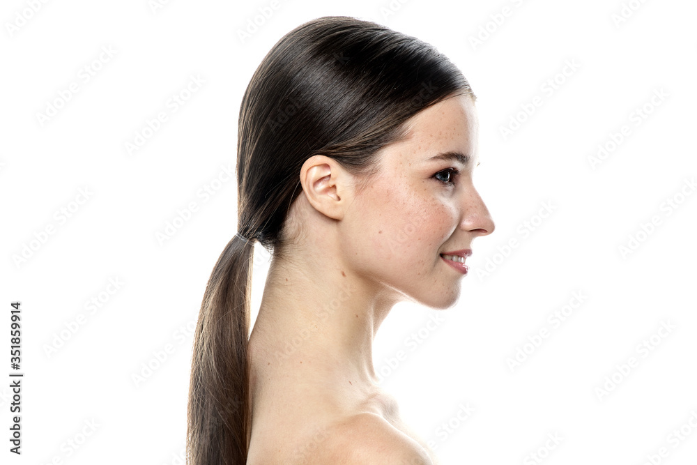 A close-up portrait of a girl with freckles and clear skin. Light blue eyes. The girl has different emotions, she looks at the camera. Isolated on a white background A close-up portrait of a girl with freckles and clear skin. Light blue eyes. The girl has different emotions, she looks at the camera. Isolated on a white background