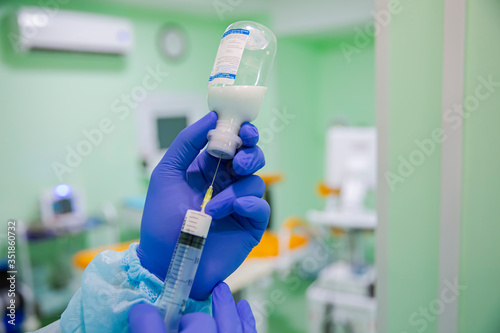 Doctor draws medicine into a syringe