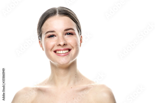 A close-up portrait of a girl with freckles and clear skin. Light blue eyes. The girl has different emotions, she looks at the camera. Isolated on a white background 