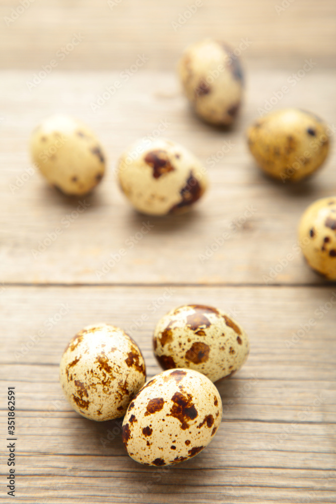 Many quail eggs on grey wooden background Many quail eggs on grey wooden background