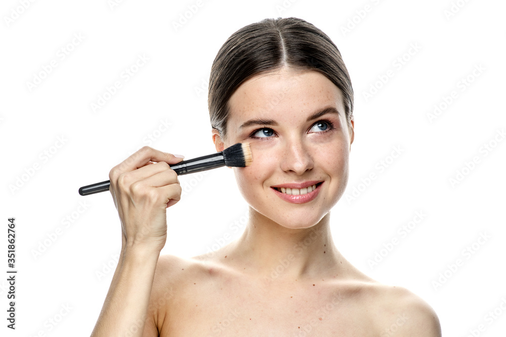 close-up portrait of a girl without makeup with clean skin with a makeup brush in hand, isolated on a white background close-up portrait of a girl without makeup with clean skin with a makeup brush in hand, isolated on a white background