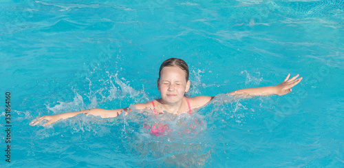 the girl can t swim and is afraid of drowning. Child having fun in swimming pool. Kid playing outdoors. Summer vacation and healthy lifestyle concept