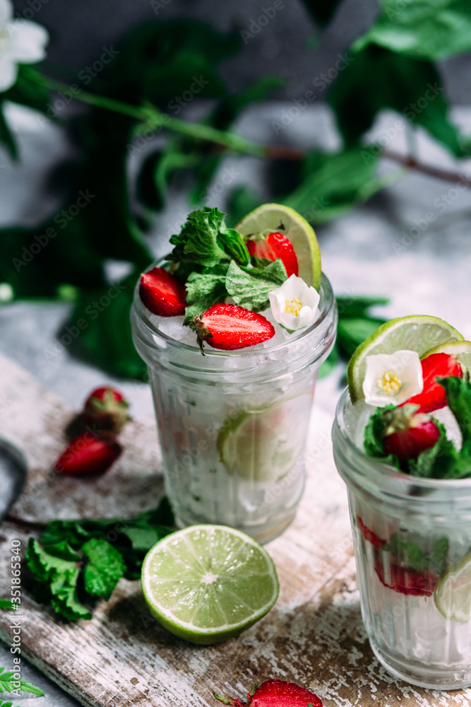 Mojito cocktail with strawberries, mint and lime. Lemonade Mojito cocktail with strawberries, mint and lime. Lemonade