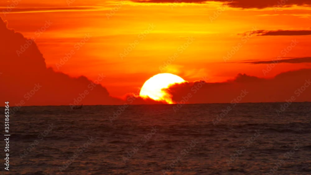 sunset in deep ocean, silhouette mountain cape long distance with beautiful cloudy colorful orange twilight sky background at evening time, long tail fishing boat sailing in sea sunset in deep ocean, silhouette mountain cape long distance with beautiful cloudy colorful orange twilight sky background at evening time, long tail fishing boat sailing in sea
