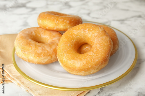 Delicious glazed donuts on marble table, closeup © New Africa