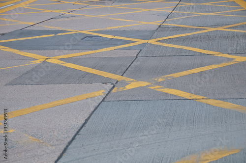 Abstract yellow painted traffic line pattern on concrete road street background © eyeofpaul