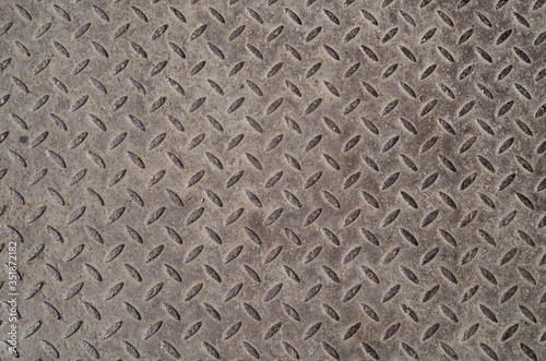 Old industrial metal plate with diamond pattern. Texture. Background.