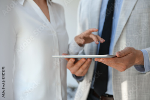 Business people working with modern tablet in office, closeup