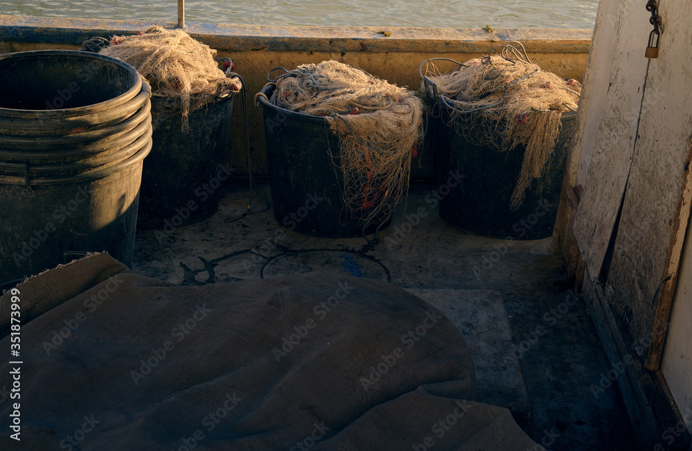 some fishing nets stuffed into three baskets inside the boat, some fishing nets stuffed into three baskets inside the boat,