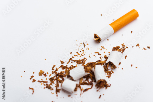31 May of World No Tobacco Day, no smoking, close up of broken pile cigarette or tobacco STOP symbolic on white background with copy space, and Warning lung health concept