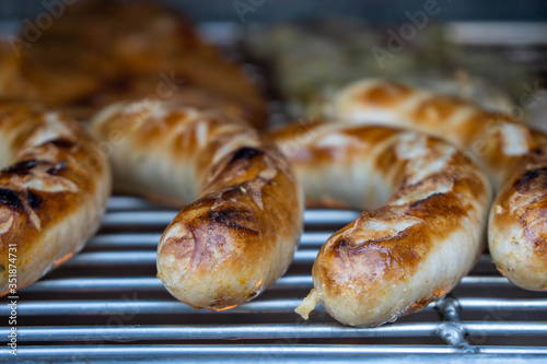 sausages or german bratwurst on a grill or barbecue