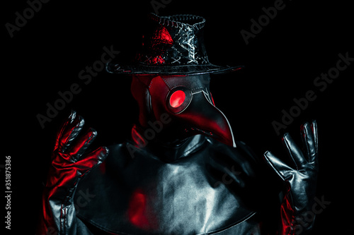Photography Portrait of plague doctor with crow-like mask isolated on black background