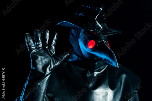 Obraz na płótnie Man in plague doctor costume with crow-like mask disapproving with NO hand sign gesture