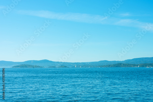 Seascape on sunny summer day as background with copy space. Summer vacation and business travel concept.