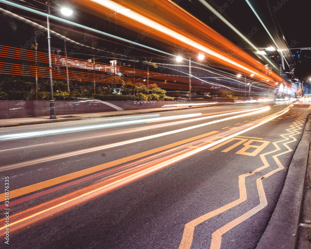 NEWTON, SINGAPORE - DECEMBER 2019: A LONG EXPOSURE of a public bus zooming past on the road in Singapore at night NEWTON, SINGAPORE - DECEMBER 2019: A LONG EXPOSURE of a public bus zooming past on the road in Singapore at night