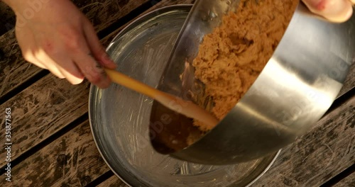 Whisking cake mix in a silver bowl