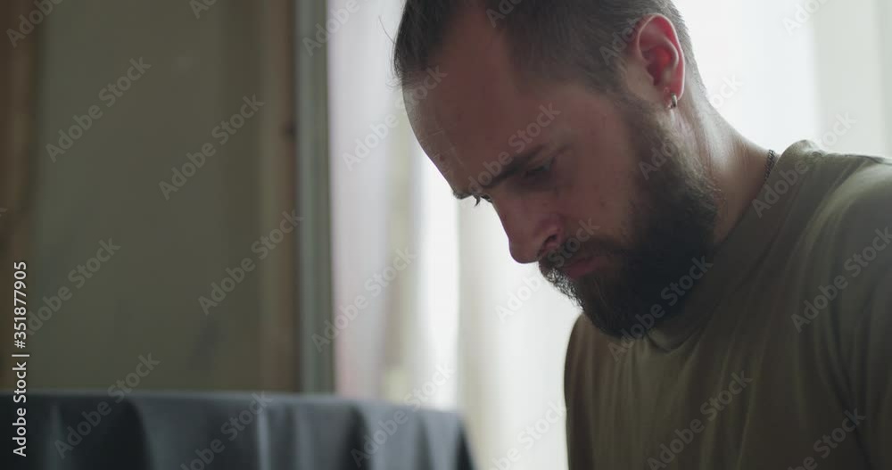 Portrait of serious man using mobile phone in a room
