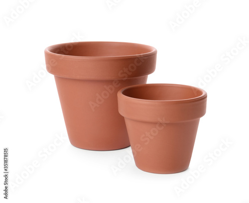 Stylish terracotta flower pots isolated on white