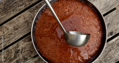 Putting syrup in freshly baked cake