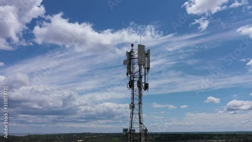 Closeup aerial shot of a telecommunication tower in a rural location. Telecommunication antennas and satellite dishes transmit 5g 4g cellular signals to consumers and smartphones