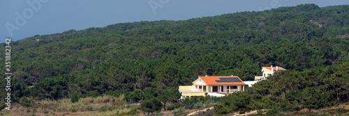 Obraz na płótnie Single farmhouse with modern solar panels on a roof in forest w salonie