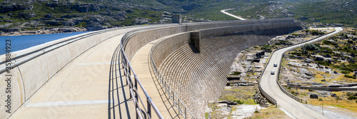 Obraz na płótnie Dam on a mountain river and lake. Huge and long concrete construction w salonie
