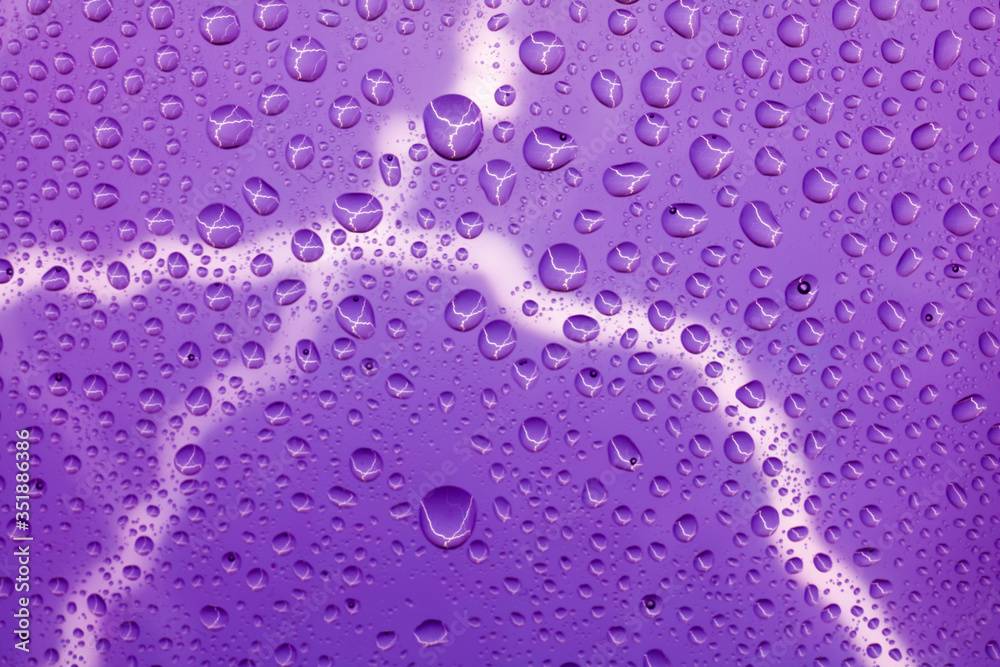 Lightning bolt on the background of raindrops on the glass Lightning bolt on the background of raindrops on the glass