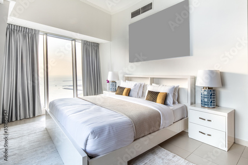 Elegant Bedroom of a High Rise Apartment Overlooking Marina During Sunset