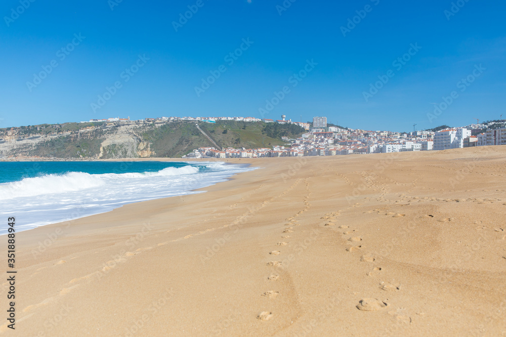 Traces on the sand of the beach in Nazare Portugal Traces on the sand of the beach in Nazare Portugal