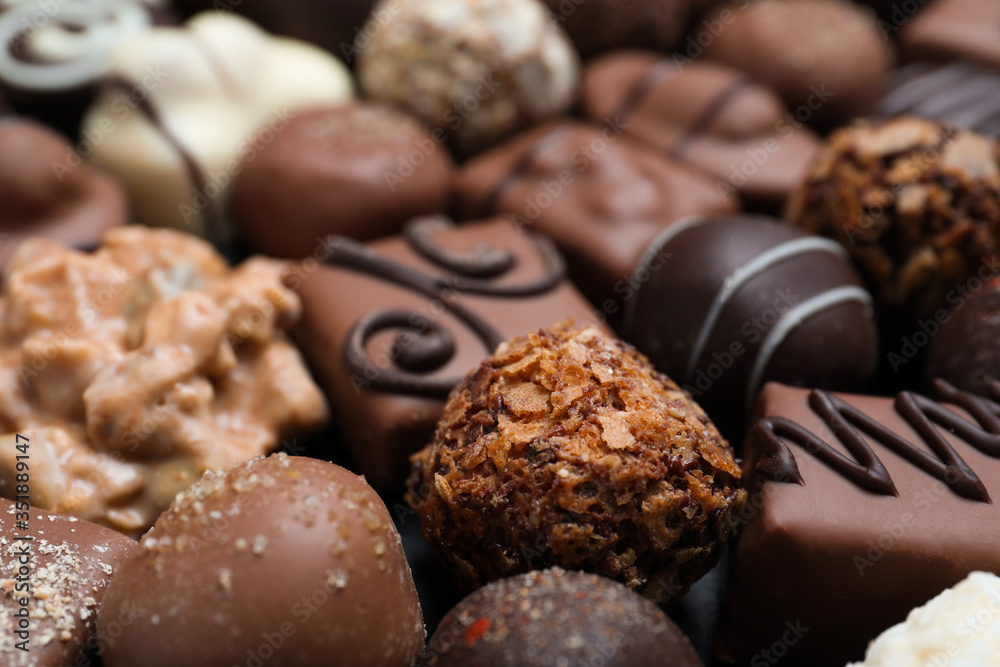 Different delicious chocolate candies as background, closeup