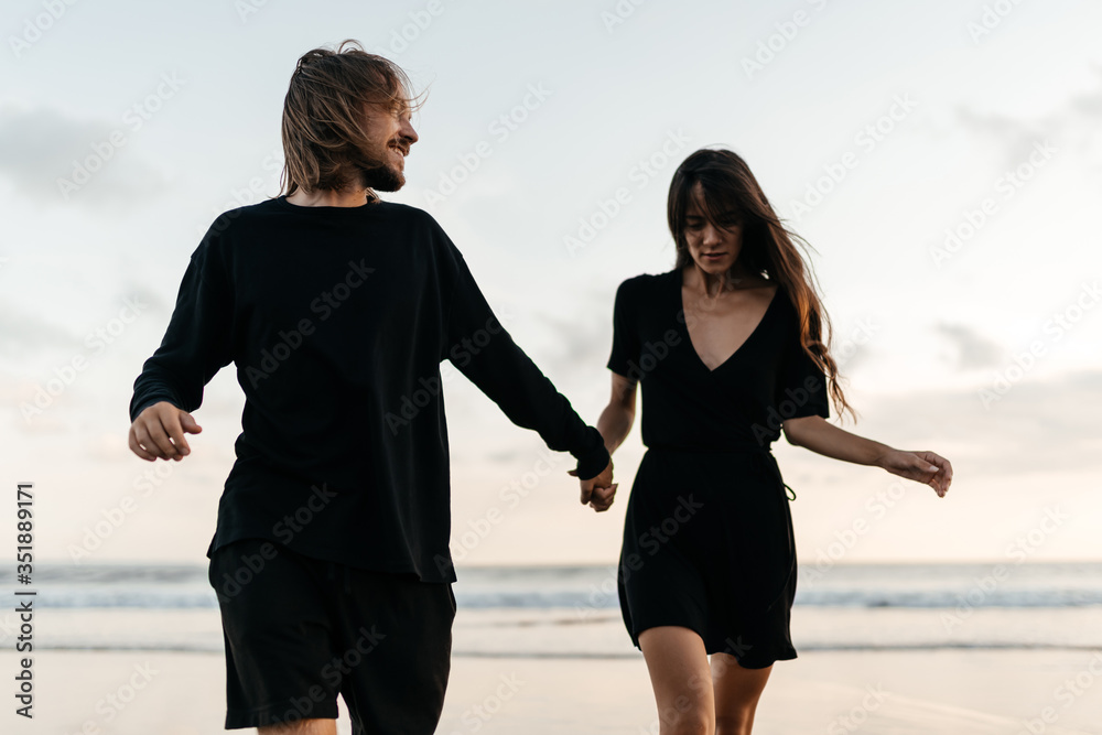 Fototapeta premium Young couple in love, Attractive man and woman enjoying romantic evening on sunset