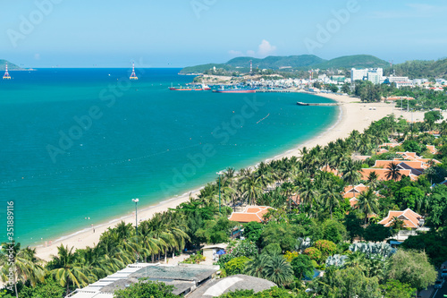 Sea bay with boats and palm trees on the beach and mountains © Евгений Дубасов