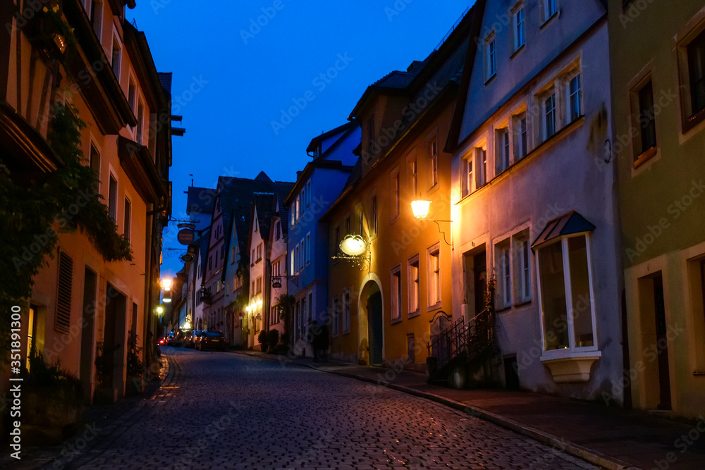 Night view to narrow medieval street in old town Rothenburg ob der Tauber, Bavaria, Germany. November 2014