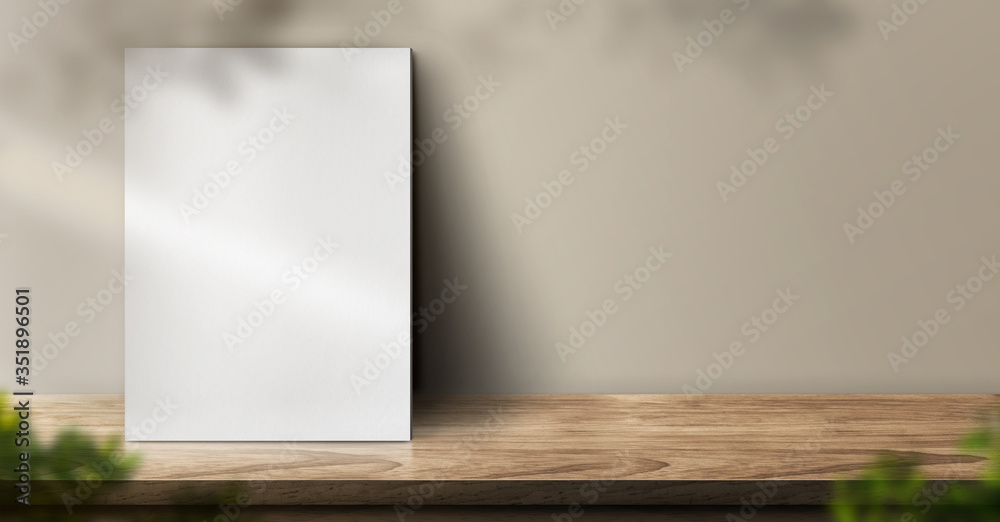 blank poster on wood table background with sunlight window create