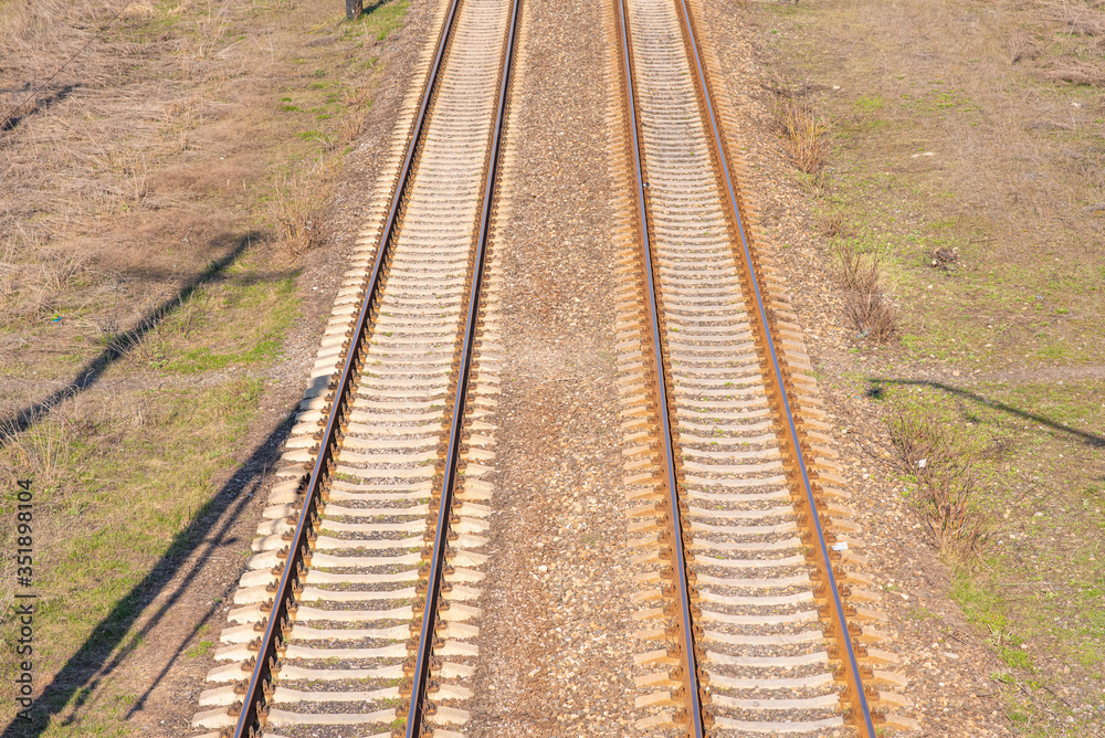 Old slightly rusty railroad tracks on which trains still ride.