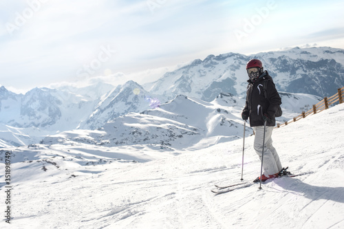 Female skier enjoy in beautiful snowy alps mountain range scenic. Winter season sport and recreation travel concept