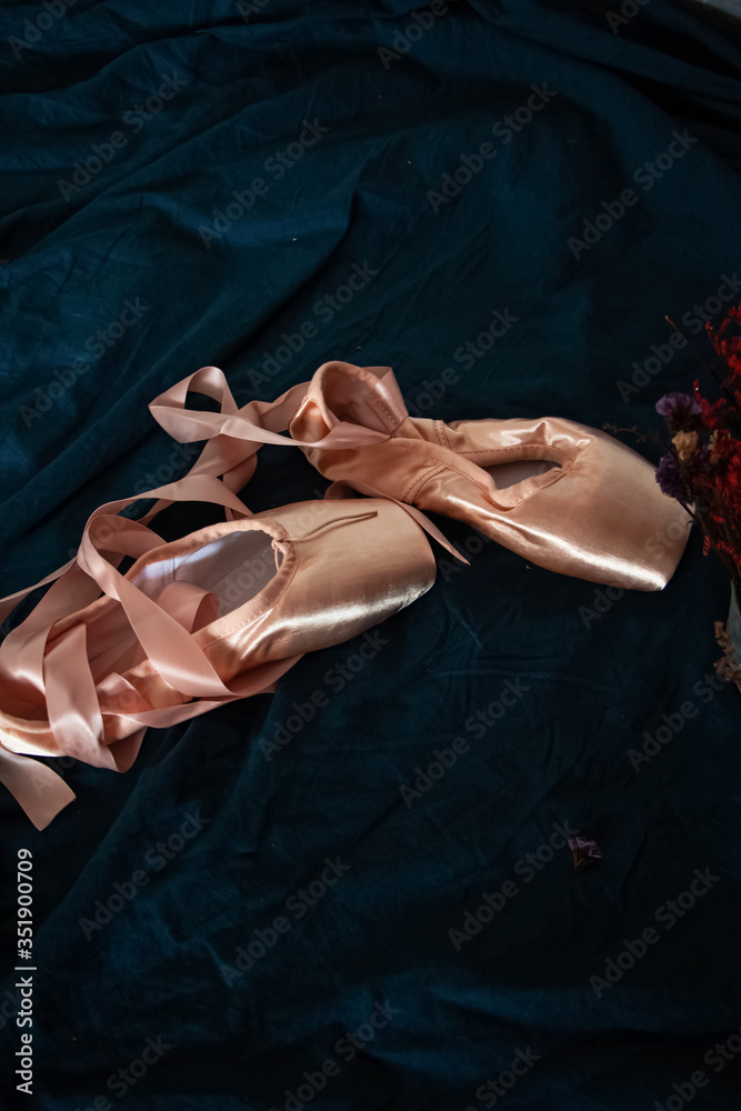 Closeup pair of ballet shoe put at the middle of background,vintage tone