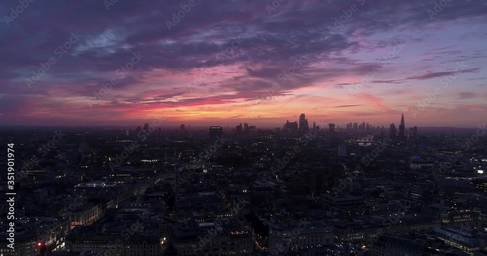 London skyline at sunrise, lights on buildings and London Eye London skyline at sunrise, lights on buildings and London Eye