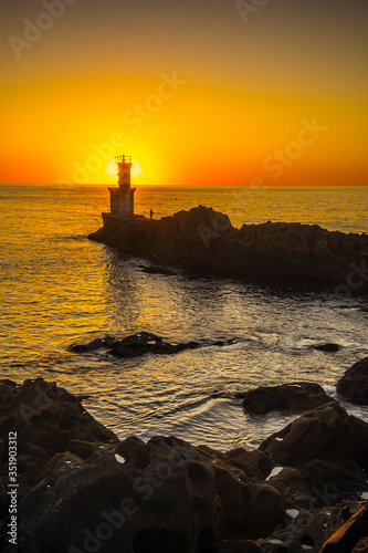 Orange sunset at the Lighthouse in Pasajes San Juan, Guipuzcoa. Basque Country, vertical photo